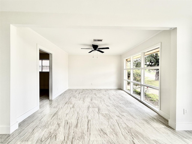 4015 Leeshire Dr, Houston, TX 77025 - spare room featuring crown molding, healthy amount of natural light, a ceiling fan, and marble finish floors
