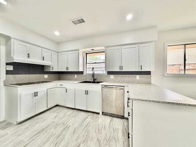 4015 Leeshire Dr, Houston, TX 77025 - kitchen featuring dishwasher, tasteful backsplash, a peninsula, black electric stovetop, and white cabinetry