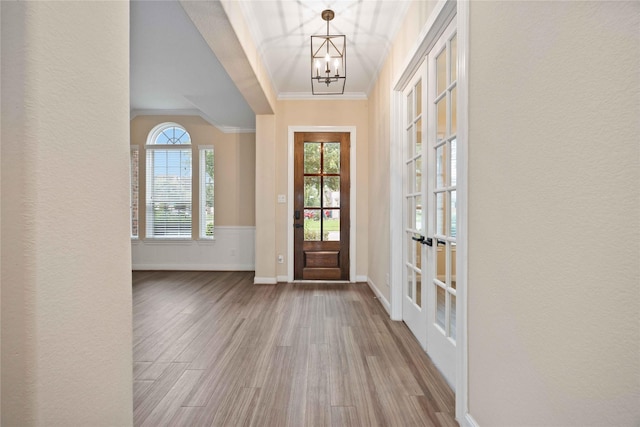 13721 Northline Lake Dr, Houston, TX 77044 - entryway with crown molding, wood finished floors, and a chandelier