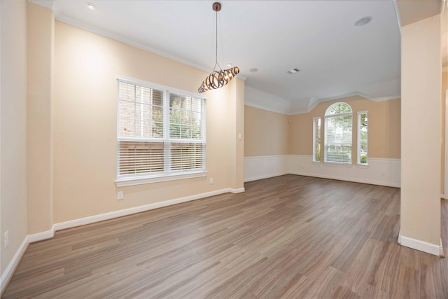 13721 Northline Lake Dr, Houston, TX 77044 - empty room featuring light wood-type flooring, vaulted ceiling, crown molding, and wainscoting