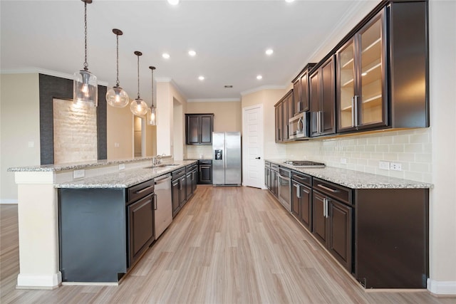 13721 Northline Lake Dr, Houston, TX 77044 - kitchen featuring appliances with stainless steel finishes, dark brown cabinetry, decorative backsplash, light wood finished floors, and ornamental molding