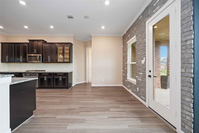 13721 Northline Lake Dr, Houston, TX 77044 - kitchen with stainless steel appliances, ornamental molding, decorative backsplash, light wood-style flooring, and recessed lighting