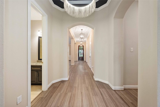 13721 Northline Lake Dr, Houston, TX 77044 - corridor with light wood-type flooring, arched walkways, and crown molding