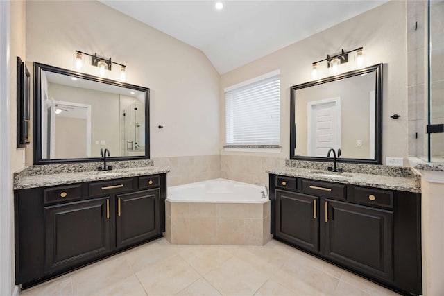 13721 Northline Lake Dr, Houston, TX 77044 - bathroom featuring lofted ceiling, a garden tub, two vanities, and tile patterned flooring