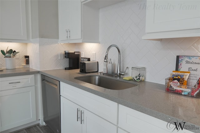 5902 Gardendale Dr Unit C, Houston, TX 77092 - kitchen with stainless steel dishwasher, white cabinets, decorative backsplash, and dark stone countertops