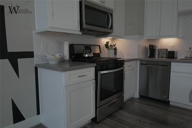 5902 Gardendale Dr Unit C, Houston, TX 77092 - kitchen with stainless steel appliances, white cabinets, dark wood finished floors, and tasteful backsplash