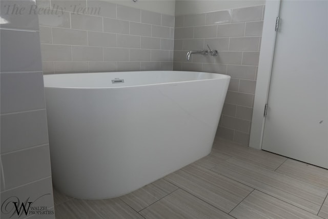 5902 Gardendale Dr Unit C, Houston, TX 77092 - full bathroom featuring tile walls, a soaking tub, and tile patterned floors