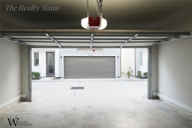 5902 Gardendale Dr Unit C, Houston, TX 77092 - garage featuring a garage door opener and baseboards