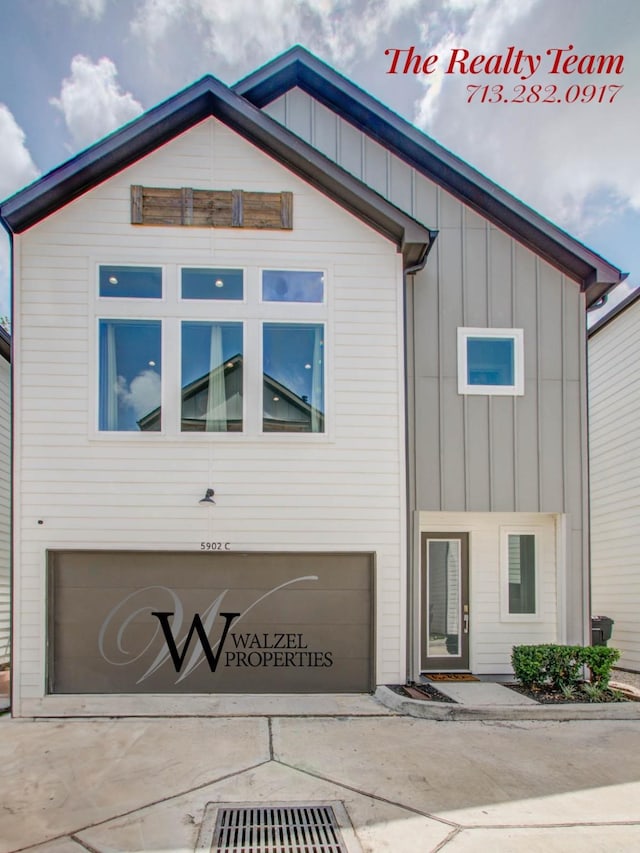 5902 Gardendale Dr Unit C, Houston, TX 77092 - view of front of house featuring an attached garage, driveway, and board and batten siding