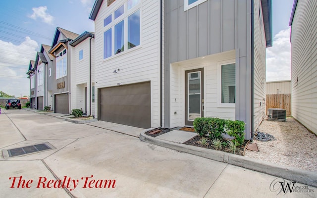 5902 Gardendale Dr Unit C, Houston, TX 77092 - view of front of house with board and batten siding, an attached garage, and concrete driveway