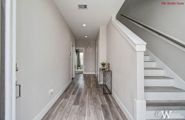 5902 Gardendale Dr Unit C, Houston, TX 77092 - hallway with recessed lighting, wood finished floors, and stairway