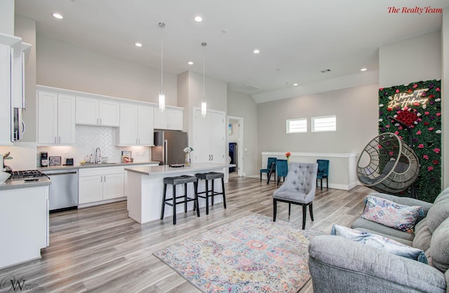 5902 Gardendale Dr Unit C, Houston, TX 77092 - living area featuring light wood-type flooring, recessed lighting, and a towering ceiling