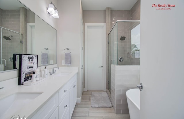 5902 Gardendale Dr Unit C, Houston, TX 77092 - full bathroom featuring a shower stall, double vanity, and a freestanding tub