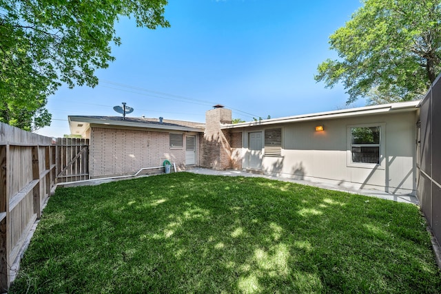 1033 25th Ave N, Texas City, TX 77590 - back of house featuring a fenced backyard, a chimney, and brick siding
