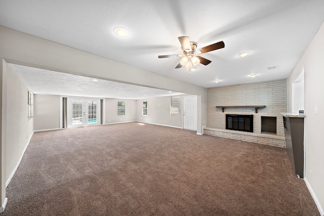 1033 25th Ave N, Texas City, TX 77590 - unfurnished living room with a brick fireplace, carpet flooring, ceiling fan, and recessed lighting