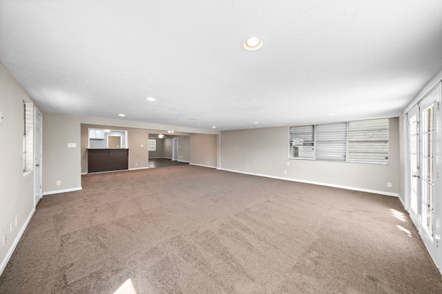 1033 25th Ave N, Texas City, TX 77590 - unfurnished living room with carpet floors and recessed lighting