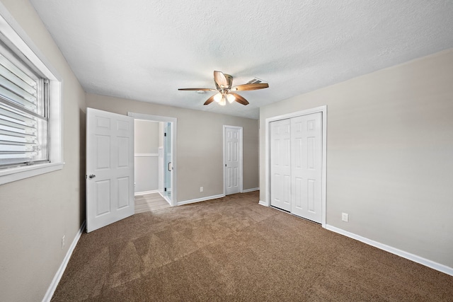 1033 25th Ave N, Texas City, TX 77590 - unfurnished bedroom with carpet flooring, a closet, ceiling fan, and a textured ceiling