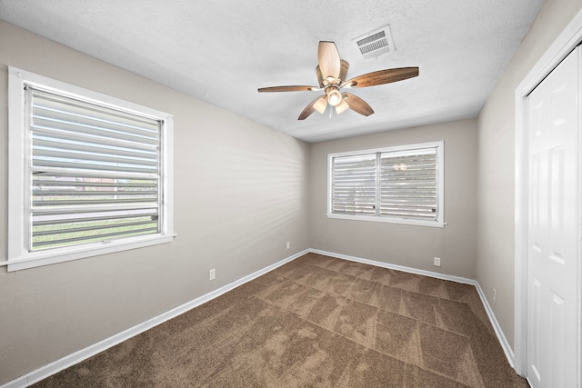1033 25th Ave N, Texas City, TX 77590 - unfurnished room with carpet, a ceiling fan, healthy amount of natural light, and a textured ceiling