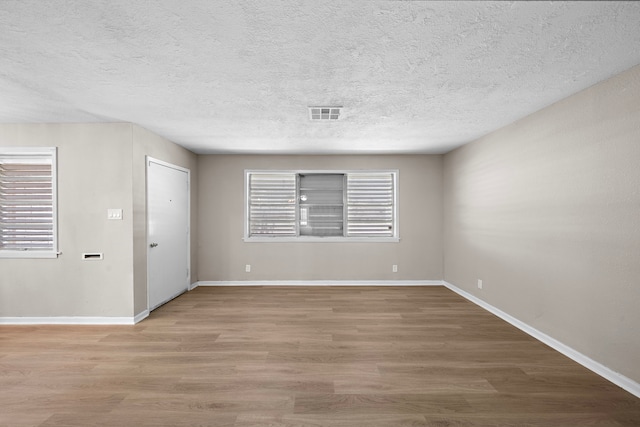 1033 25th Ave N, Texas City, TX 77590 - unfurnished room featuring wood finished floors and a textured ceiling
