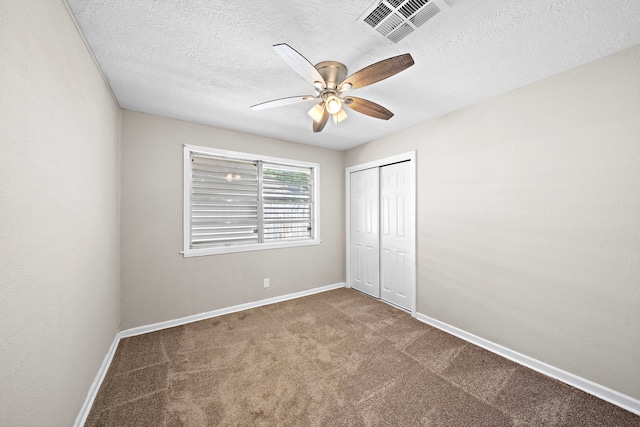 1033 25th Ave N, Texas City, TX 77590 - unfurnished bedroom with carpet floors, a textured ceiling, a closet, and a ceiling fan