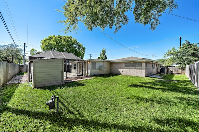 1033 25th Ave N, Texas City, TX 77590 - rear view of house with a fenced backyard, brick siding, and glass enclosure