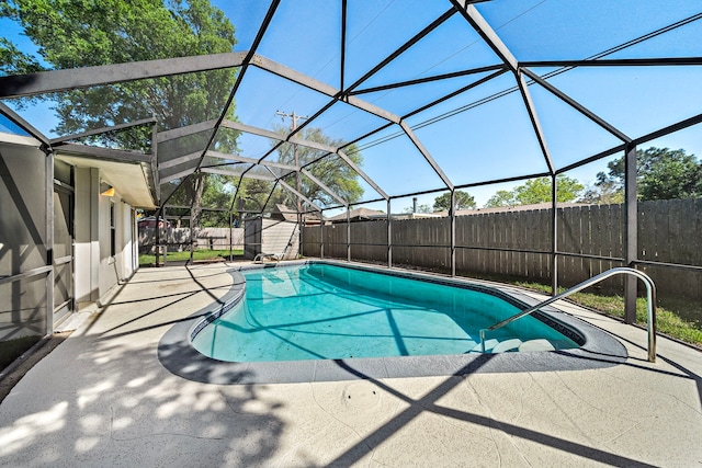 1033 25th Ave N, Texas City, TX 77590 - view of swimming pool featuring a patio area, a fenced backyard, a lanai, and a storage unit