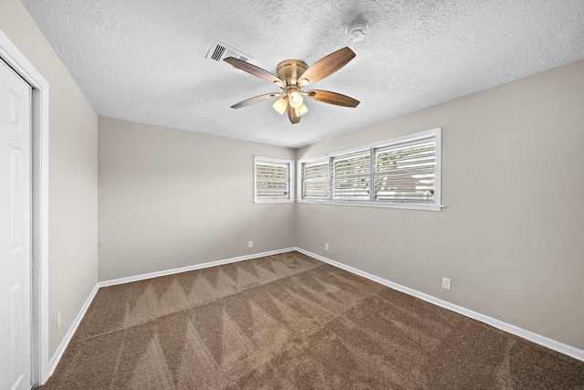 1033 25th Ave N, Texas City, TX 77590 - spare room featuring carpet flooring, a ceiling fan, a textured ceiling, and a smoke detector