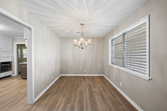 1033 25th Ave N, Texas City, TX 77590 - unfurnished dining area featuring wood finished floors and a chandelier