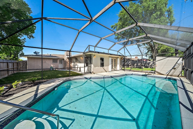 1033 25th Ave N, Texas City, TX 77590 - view of swimming pool with a fenced backyard, a patio, glass enclosure, and an outbuilding
