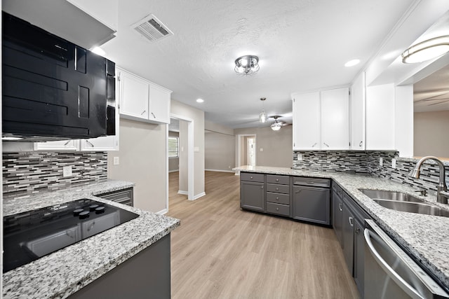1033 25th Ave N, Texas City, TX 77590 - kitchen with dishwasher, a peninsula, ceiling fan, white cabinets, and light wood finished floors