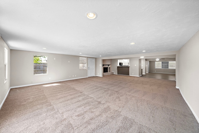 1033 25th Ave N, Texas City, TX 77590 - unfurnished living room featuring carpet flooring, recessed lighting, and ceiling fan