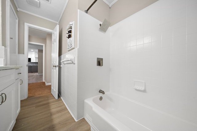 1033 25th Ave N, Texas City, TX 77590 - bathroom featuring ornamental molding, wood finished floors, shower / washtub combination, vanity, and tile walls