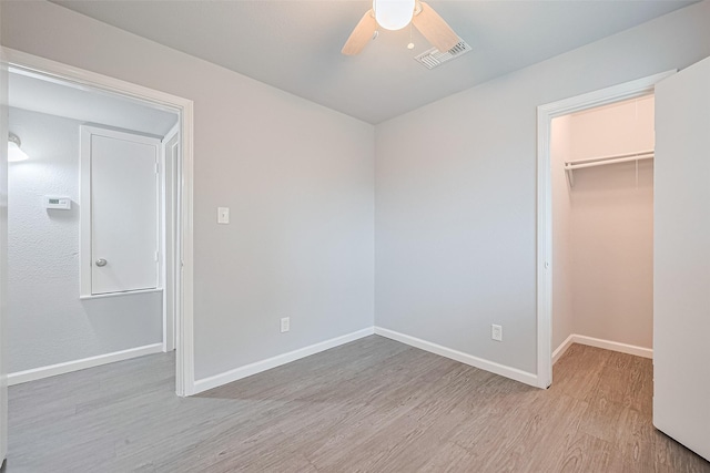 3602 Castledale Dr, Houston, TX 77093 - unfurnished bedroom featuring light wood-type flooring, a spacious closet, a closet, and a ceiling fan