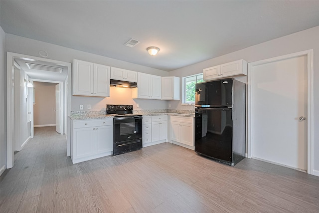 3602 Castledale Dr, Houston, TX 77093 - kitchen with black appliances, under cabinet range hood, light wood-type flooring, and white cabinets