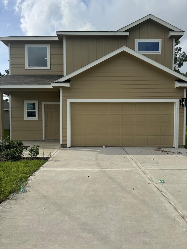 1571 Belton Ln, Anahuac, TX 77514 - view of front of house with board and batten siding and concrete driveway