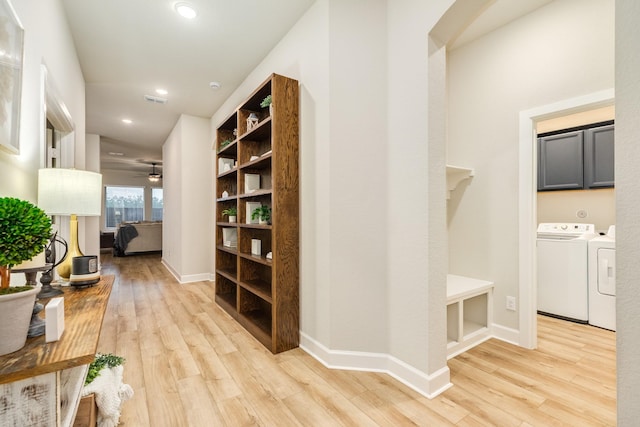 9806 Starry Night Ln, Manvel, TX 77578 - corridor featuring independent washer and dryer, light wood-type flooring, and recessed lighting
