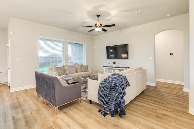 9806 Starry Night Ln, Manvel, TX 77578 - living room with arched walkways, light wood-style flooring, and a ceiling fan