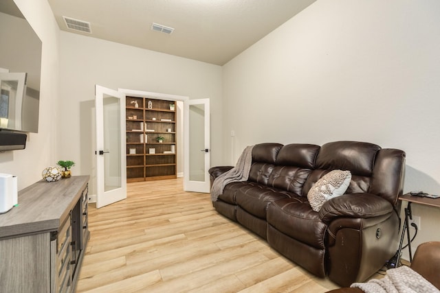 9806 Starry Night Ln, Manvel, TX 77578 - living area featuring french doors and light wood finished floors