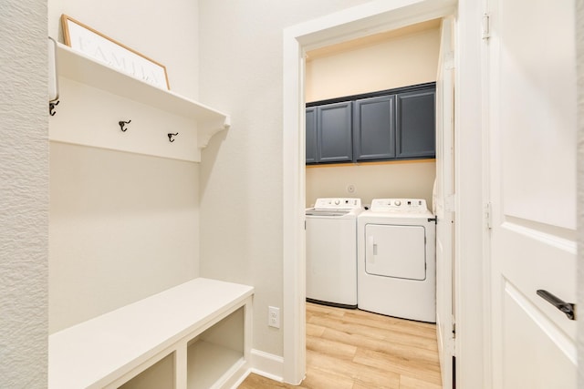 9806 Starry Night Ln, Manvel, TX 77578 - washroom with cabinet space, separate washer and dryer, and light wood-style flooring