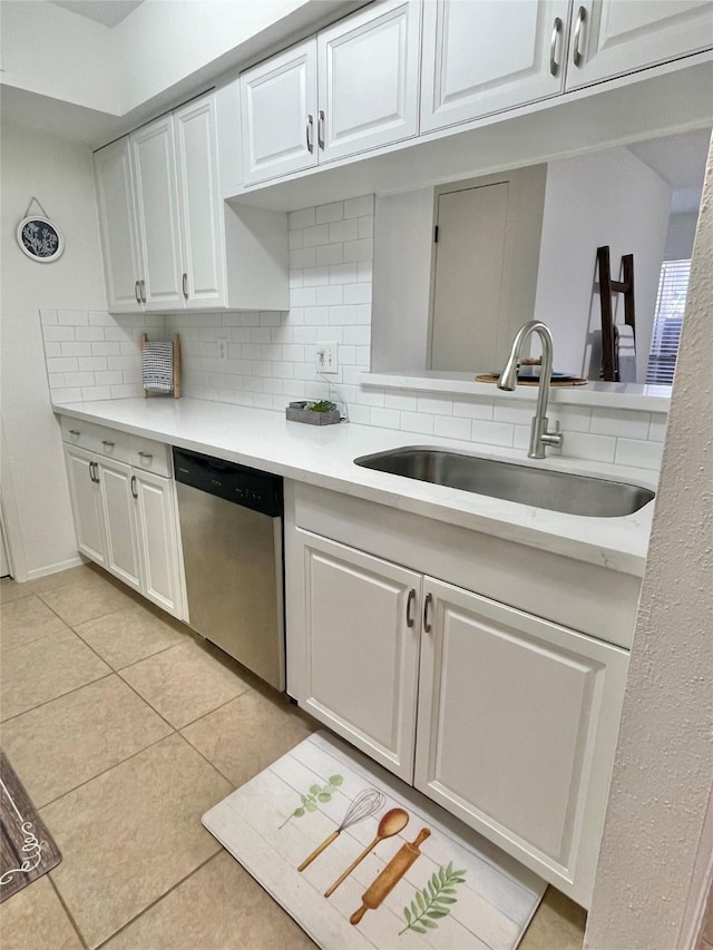 3300 Pebblebrook Dr Unit 17, Seabrook, TX 77586 - kitchen with stainless steel dishwasher, backsplash, light countertops, and light tile patterned floors