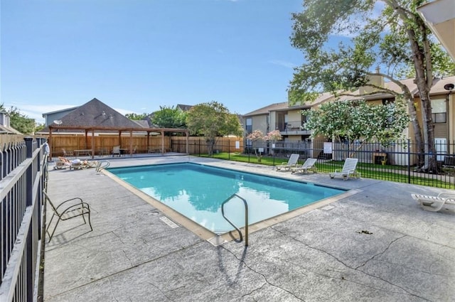 3300 Pebblebrook Dr Unit 17, Seabrook, TX 77586 - community pool with a patio area, a fenced backyard, and a residential view
