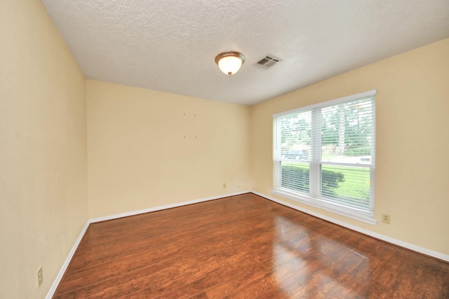346 Ballantrae Ln, Houston, TX 77015 - empty room featuring dark wood-type flooring and a textured ceiling
