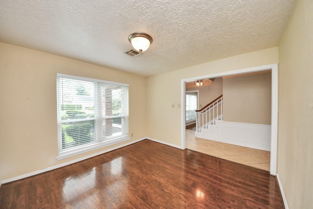 346 Ballantrae Ln, Houston, TX 77015 - spare room with wood finished floors, a textured ceiling, and stairway