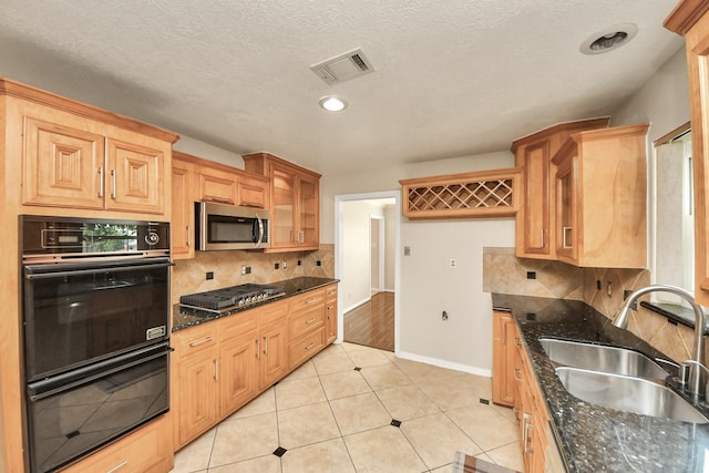 346 Ballantrae Ln, Houston, TX 77015 - kitchen with stainless steel appliances, backsplash, glass insert cabinets, and dark stone countertops