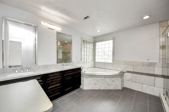 346 Ballantrae Ln, Houston, TX 77015 - full bath featuring a stall shower, a bath, double vanity, recessed lighting, and tile patterned floors