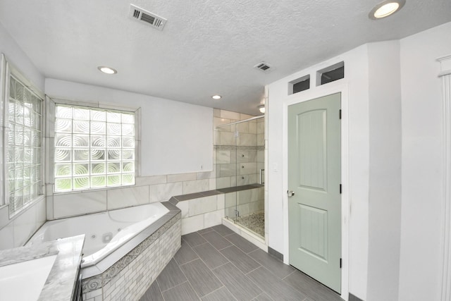 346 Ballantrae Ln, Houston, TX 77015 - full bath with a stall shower, a jetted tub, recessed lighting, tile patterned flooring, and a textured ceiling