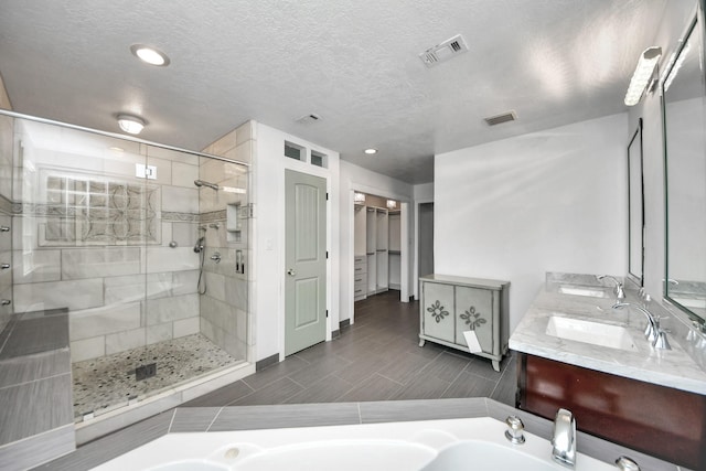 346 Ballantrae Ln, Houston, TX 77015 - bathroom with a shower stall, double vanity, a bath, recessed lighting, and a textured ceiling