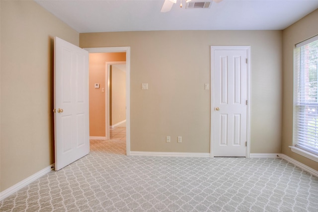 2115 Greentree Dr, Huntsville, TX 77340 - unfurnished bedroom featuring light colored carpet and a ceiling fan