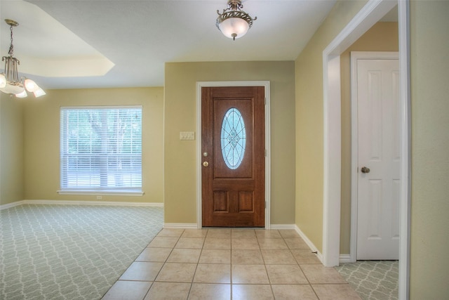 2115 Greentree Dr, Huntsville, TX 77340 - foyer with a chandelier, healthy amount of natural light, light colored carpet, and light tile patterned floors