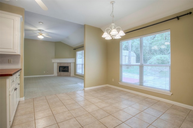 2115 Greentree Dr, Huntsville, TX 77340 - unfurnished dining area with vaulted ceiling, healthy amount of natural light, ceiling fan, light tile patterned floors, and a chandelier